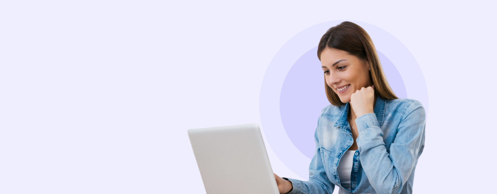 Homepage banner image of a woman smiling, sitting down while looking a laptop